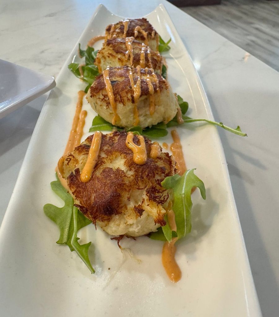 Jumbo lump crab cakes on arugula